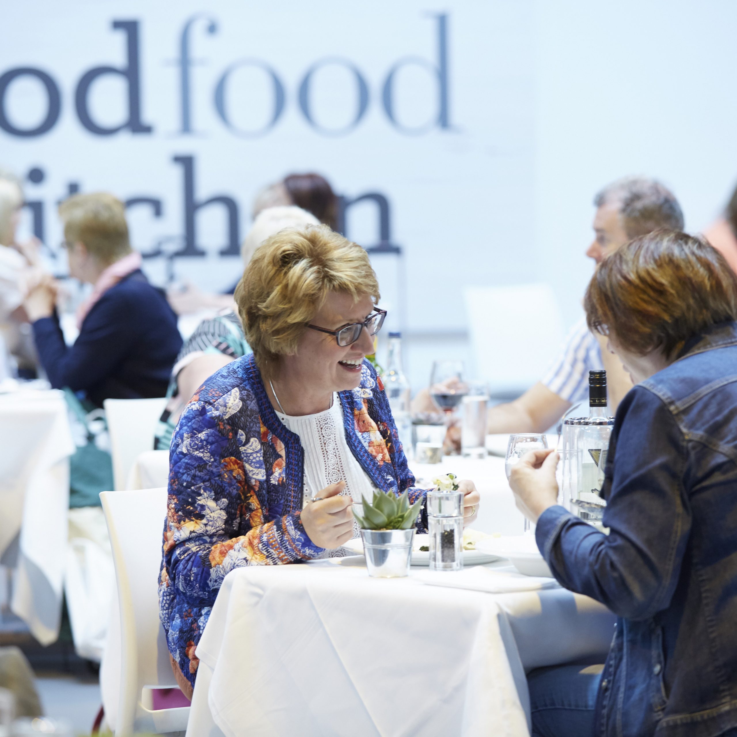 Two women enjoying their food at the BBC Good Food Restaurant. Click to find out more