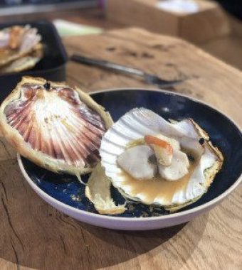 Scallops baked in their shell, flavoured with ginger